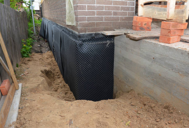 Happy homeowners after waterproofing job in Burket